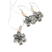 Load image into Gallery viewer, Elegant jewelry set featuring flower-shaped earrings and a matching pendant. Crafted from sterling silver and solid 9K yellow gold, with sparkling white CZ stones. This timeless set combines sophistication with nature-inspired beauty, perfect for any occasion