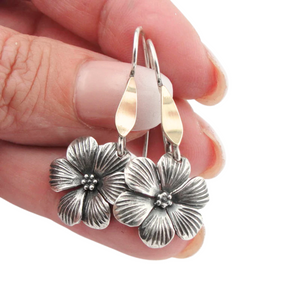 Elegant flower-shaped dangle earrings crafted from sterling silver and solid 9K yellow gold, featuring sparkling white CZ stones. These timeless earrings combine sophistication and nature-inspired beauty, perfect for everyday wear or special occasions