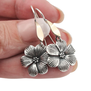 Elegant flower-shaped dangle earrings crafted from sterling silver and solid 9K yellow gold, featuring sparkling white CZ stones. These timeless earrings combine sophistication and nature-inspired beauty, perfect for everyday wear or special occasions