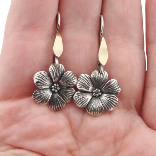 Elegant flower-shaped dangle earrings crafted from sterling silver and solid 9K yellow gold, featuring sparkling white CZ stones. These timeless earrings combine sophistication and nature-inspired beauty, perfect for everyday wear or special occasions