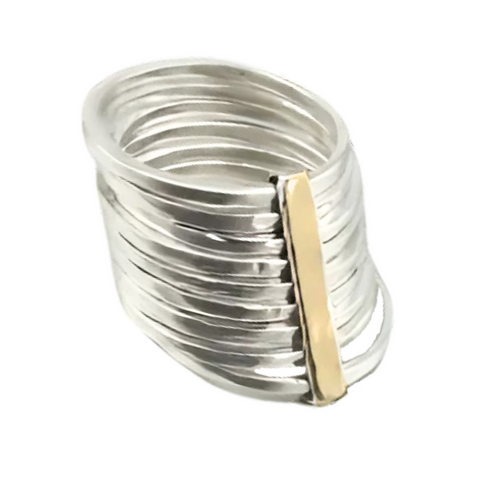 A bold stacking ring crafted from sterling silver and 9k yellow gold, featuring nine hammered silver bands held together by a sleek vertical gold bar. The wide 16mm design offers a contemporary and sophisticated look, perfect as a statement piece.
