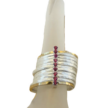 Load image into Gallery viewer, A bold and unique wide ring featuring two 9k solid yellow gold bands and eight 1mm solid sterling silver matte-textured rings. The design is accentuated by a vertical sterling silver bar adorned with sparkling ruby stones, creating a striking and elegant statement piece.
