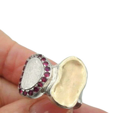 Load image into Gallery viewer, A handcrafted sterling silver and 9k yellow gold ring featuring a brushed silver surface, a polished gold accent, and a stunning border of sparkling natural ruby stones. This elegant and artistic design is a unique statement piece for any jewelry collection