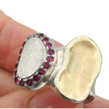 Load image into Gallery viewer, A handcrafted sterling silver and 9k yellow gold ring featuring a brushed silver surface, a polished gold accent, and a stunning border of sparkling natural ruby stones. This elegant and artistic design is a unique statement piece for any jewelry collection