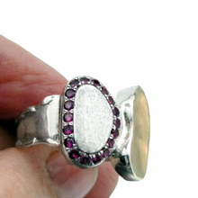 Load image into Gallery viewer, A handcrafted sterling silver and 9k yellow gold ring featuring a brushed silver surface, a polished gold accent, and a stunning border of sparkling natural ruby stones. This elegant and artistic design is a unique statement piece for any jewelry collection