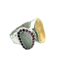 Load image into Gallery viewer, A handcrafted sterling silver and 9k yellow gold ring featuring a brushed silver surface, a polished gold accent, and a stunning border of sparkling natural ruby stones. This elegant and artistic design is a unique statement piece for any jewelry collection