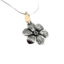 Load image into Gallery viewer, Elegant flower-shaped pendant crafted from sterling silver with a solid 9K yellow gold bail. The pendant features detailed, textured petals and a central floral design, adding a timeless and sophisticated touch. Shown hanging on a delicate silver chain.