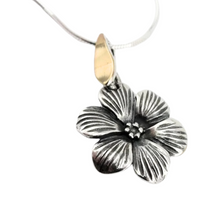 Load image into Gallery viewer, Elegant flower-shaped pendant crafted from sterling silver with a solid 9K yellow gold bail. The pendant features detailed, textured petals and a central floral design, adding a timeless and sophisticated touch. Shown hanging on a delicate silver chain.